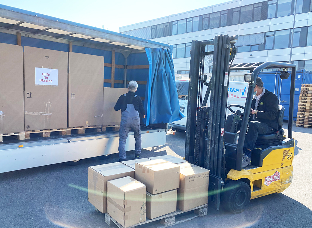 The donations in kind will be loaded for the transport to the collecting station.