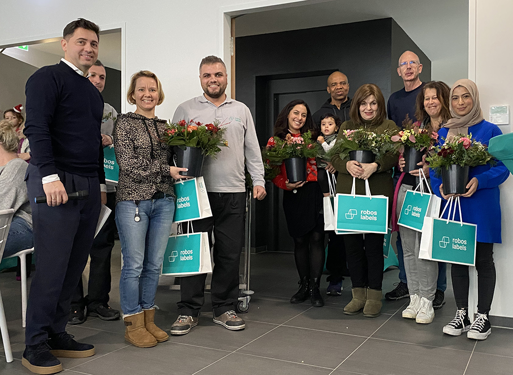 These colleagues are happy about their bouquets of flowers and 5 years of the company affiliation.